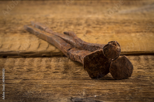 Vintage hammer with nails on wood background © romantsubin