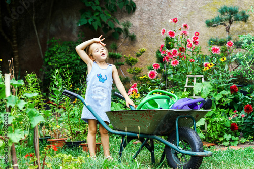 Cute little girl gardening in the backyard photo