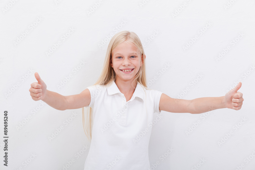 Portrait of a beautiful girl showing thumbs up on white Portrait of a beautiful girl showing thumbs up on white