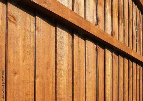Wooden garden fence close up with vertical panels and horizontal Fototapeta