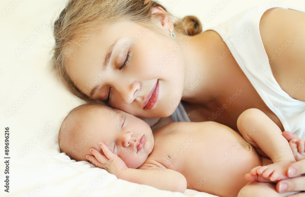 Portrait of mother and baby sleep together on the bed at home Portrait of mother and baby sleep together on the bed at home
