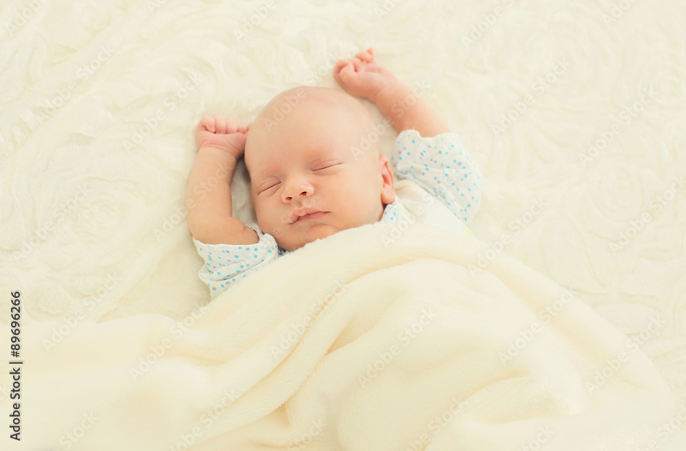 Sweet sleep infant lying on the bed at home