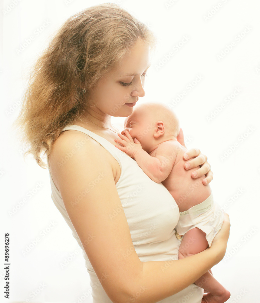 Young loving mother holding on hands sleeping infant Young loving mother holding on hands sleeping infant