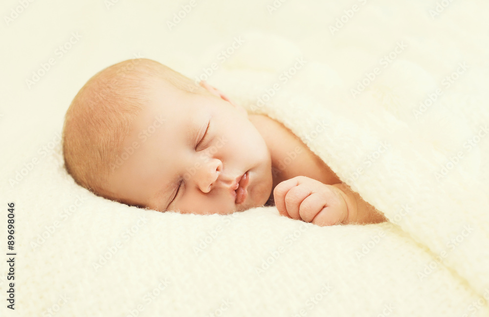 Sweet sleep baby lying under blanket on the bed at home Sweet sleep baby lying under blanket on the bed at home