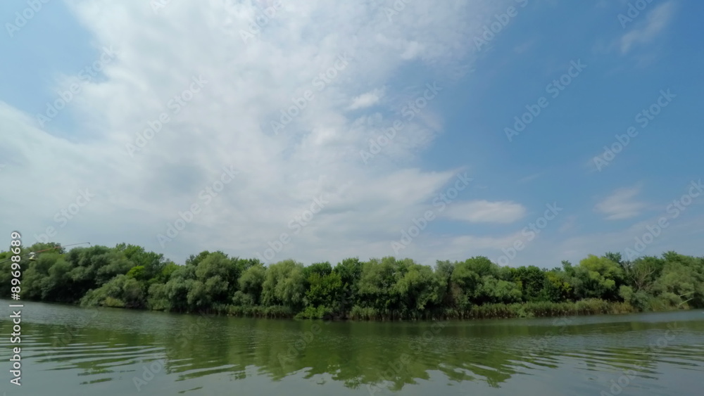 Stripe of Forest Between Cloudy Sky and River. View from Coast. Timelapse. 4K. Stripe of Forest Between Cloudy Sky and River. View from Coast. Timelapse. 4K.
