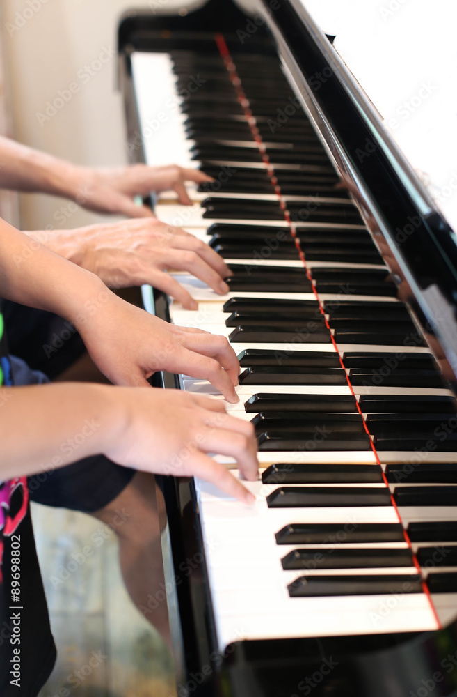 Fototapeta premium Father teaching little boy play the piano