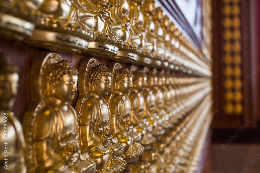 Fototapeta premium Row of golden buddha statue.