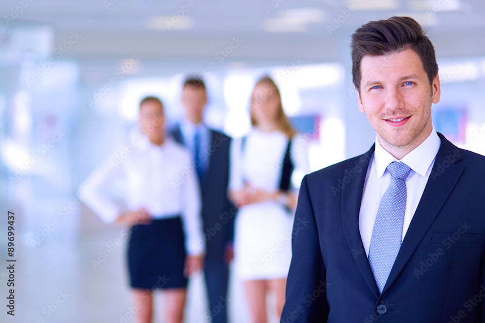 Smiling successful business team standing in office