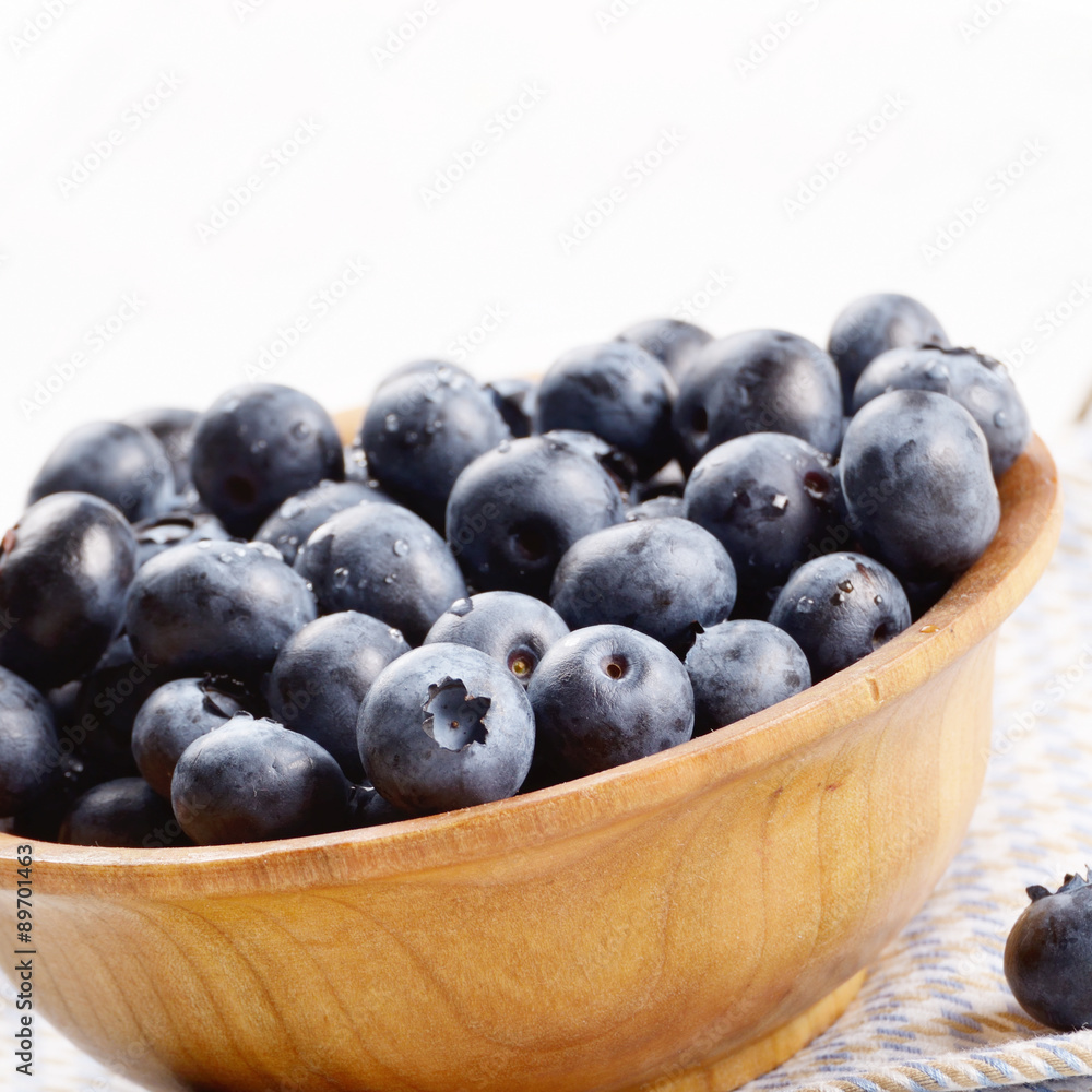 Wooden bowl with organic blueberries Wooden bowl with organic blueberries