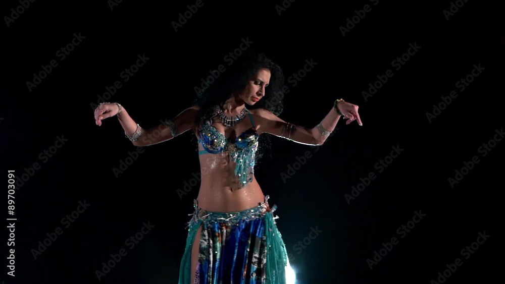 Beautiful young belly dancer in blue exotic costume continue Beautiful young belly dancer in blue exotic costume continue