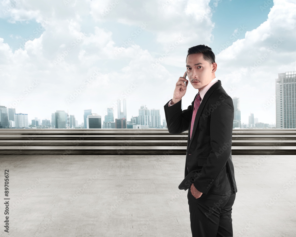 Business man calling via cellphone Business man calling via cellphone