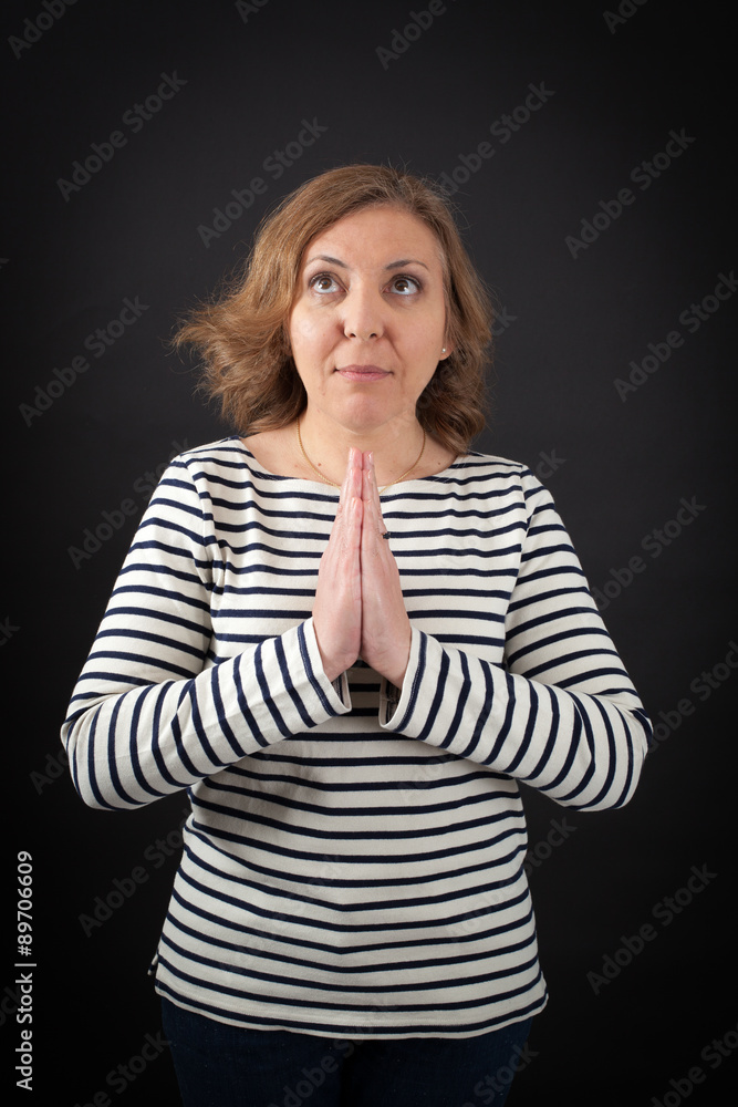 Beautiful woman doing different expressions in different sets of clothes: prayer Beautiful woman doing different expressions in different sets of clothes: prayer