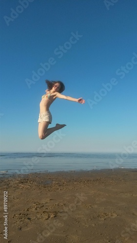 A girl jumping at the Ladoga lake