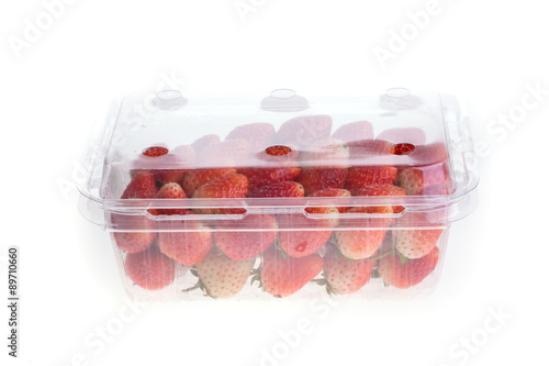 red ripe strawberry in plastic box of packaging, isolated