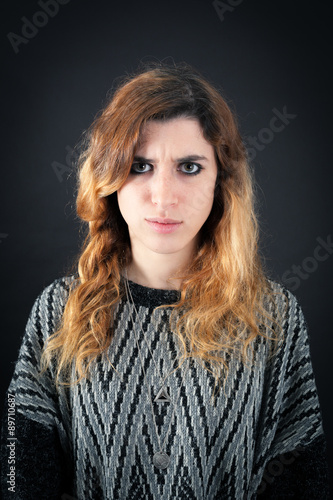 Beautiful woman doing different expressions in different sets of clothes: angry