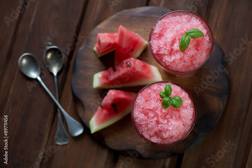 Top view of delicious watermelon granitas, rustic wooden surface photo