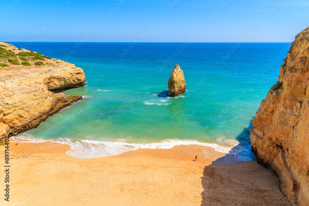 Beautiful Praia do Carvalho beach with golden rock cliffs, Portugal