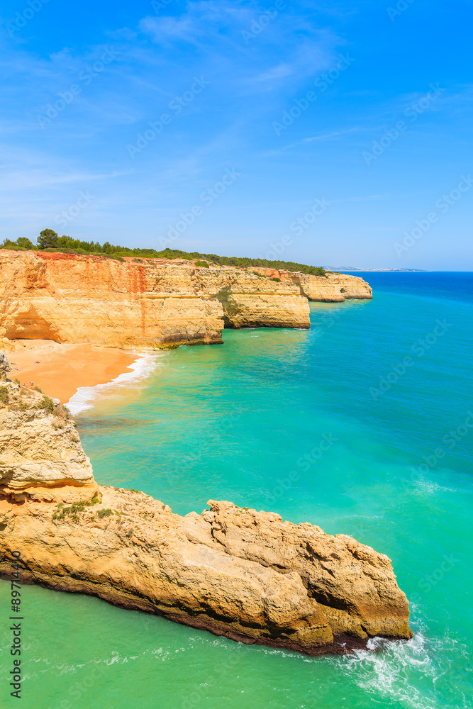 Turquoise ocean water and cliff rocks on coast of Portugal in Algarve region