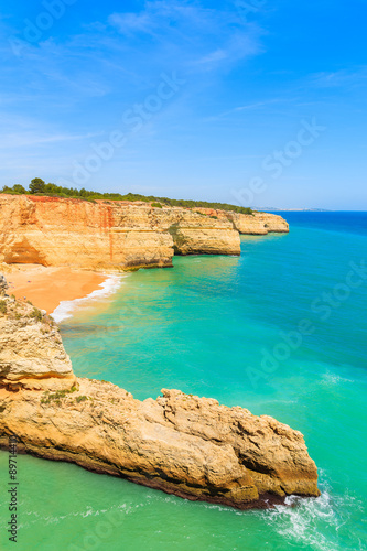 Turquoise ocean water and cliff rocks on coast of Portugal in Algarve region