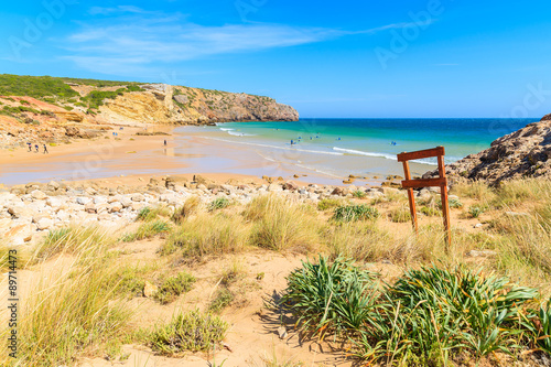 View of beautiful Zavial beach with surfers on ocean water, Portugal © pkazmierczak