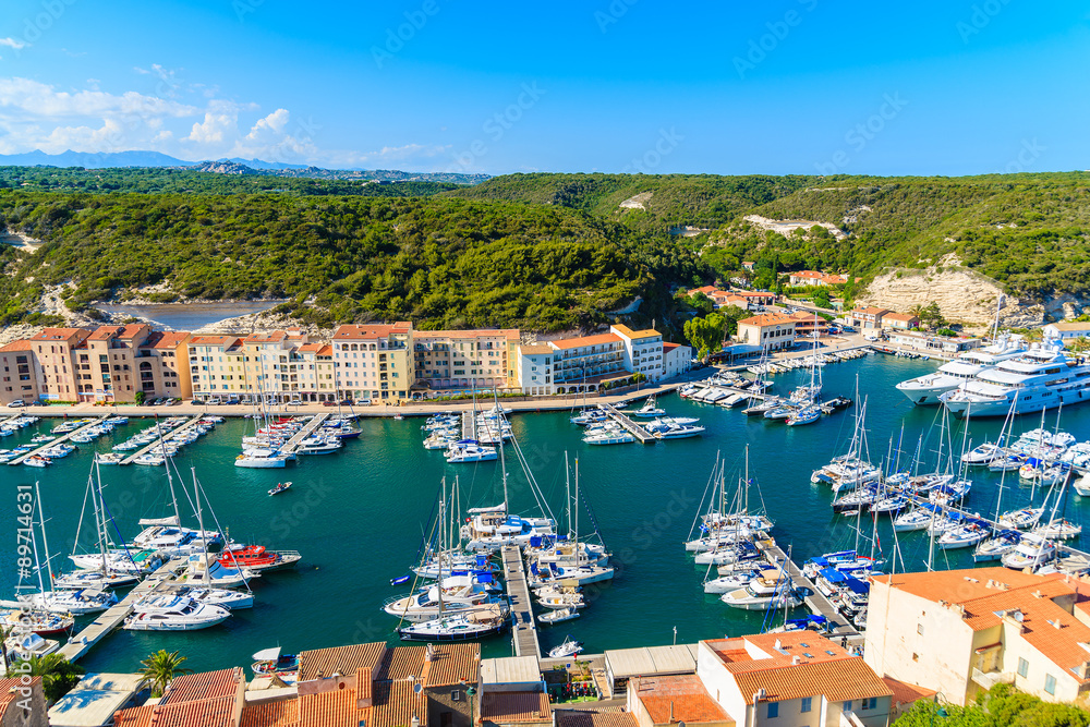 View of Bonifacio port with colorful houses and boats, Corsica island, France.