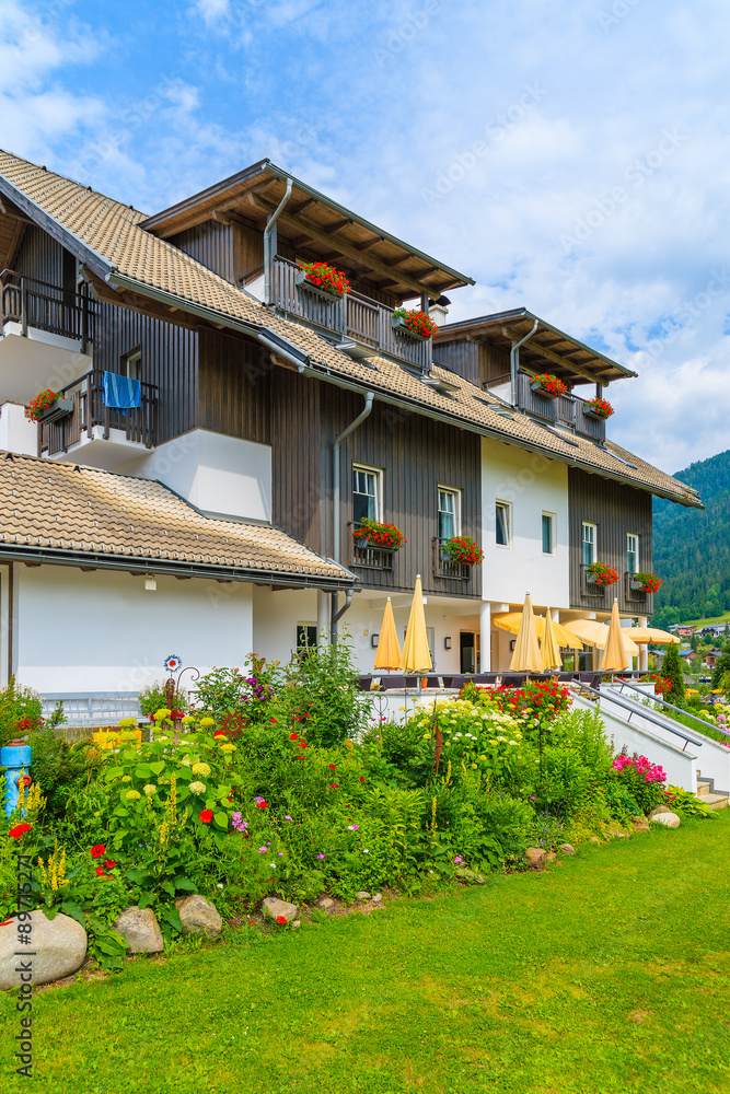 Fototapeta premium Traditional alpine house in a village on shore of Weissensee lake in summer time, Austria