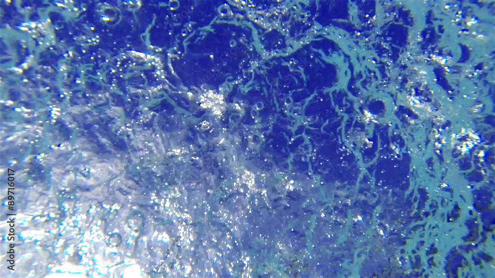 Heavy drops of water with splashes of falling into the pool Heavy drops of water with splashes of falling into the pool