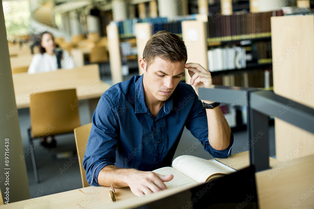 Young man in the library Young man in the library