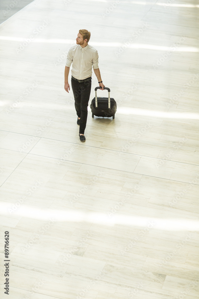 Fototapeta premium Young man with suitcase