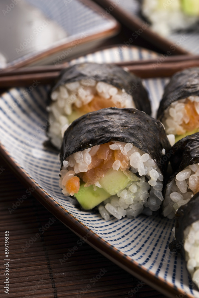 Sushi - Salmon rolls served on a plate Sushi - Salmon rolls served on a plate