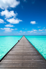 Fotobehang Pier Houten pier met helderblauwe lucht  © gawriloff