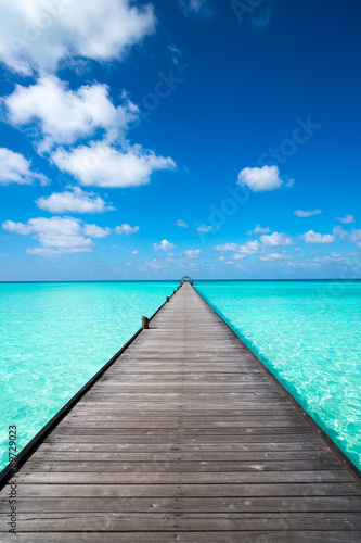 Wooden pier with blue sea and sky background © gawriloff