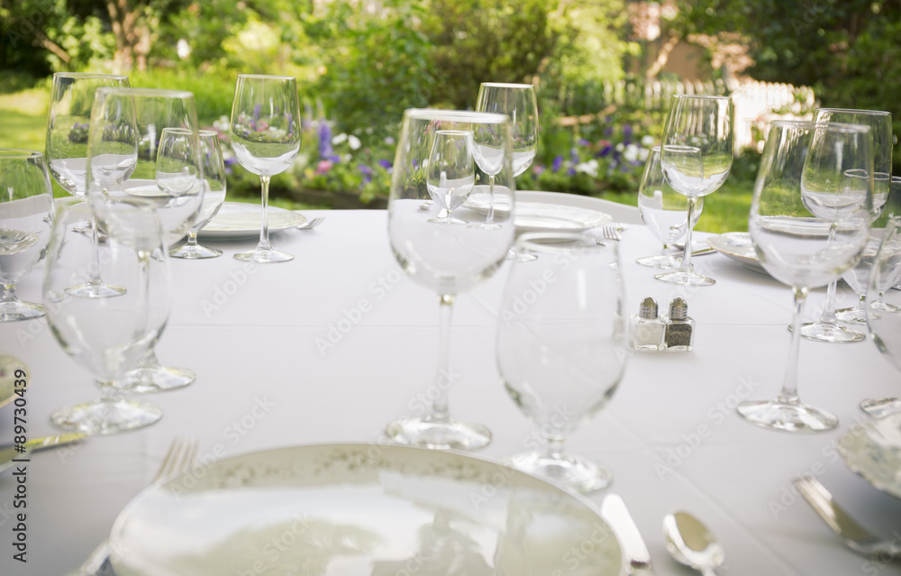 Glasses, plates, silverware on a table for a party. Glasses, plates, silverware on a table for a party.