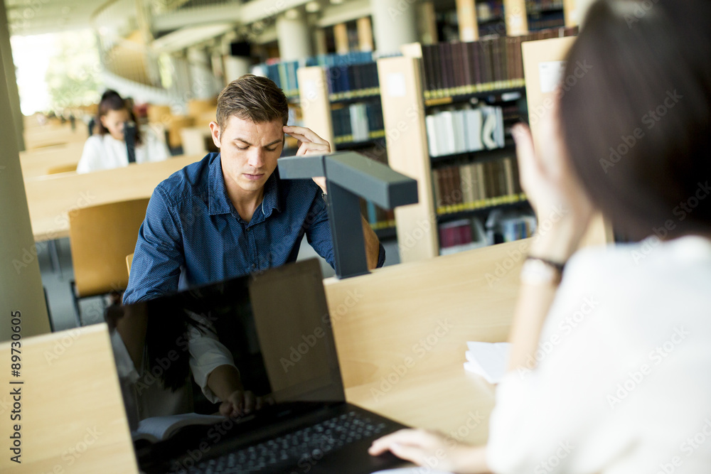 Young man in the library Young man in the library