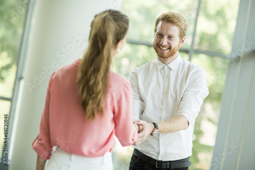 Free Download Young woman and man handshaking - GFXLoad