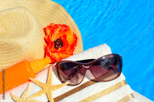 Beach hat, sunglasses, bath towel, sun spray, starfish near