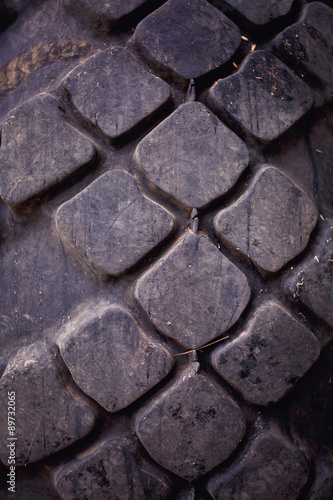 Close-up of tractor tire tread as background.