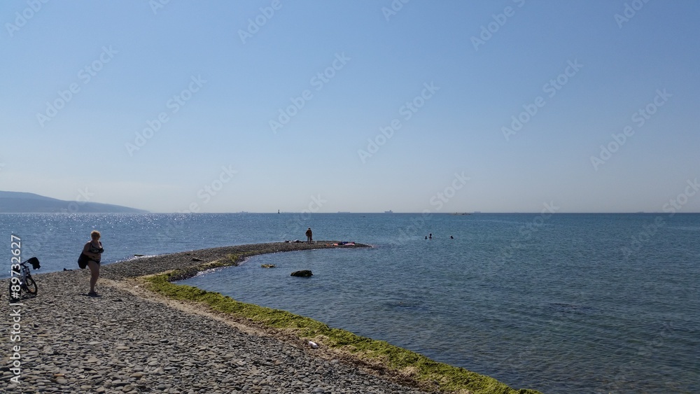 Picture of sea beach in shiny cloudless summer day.