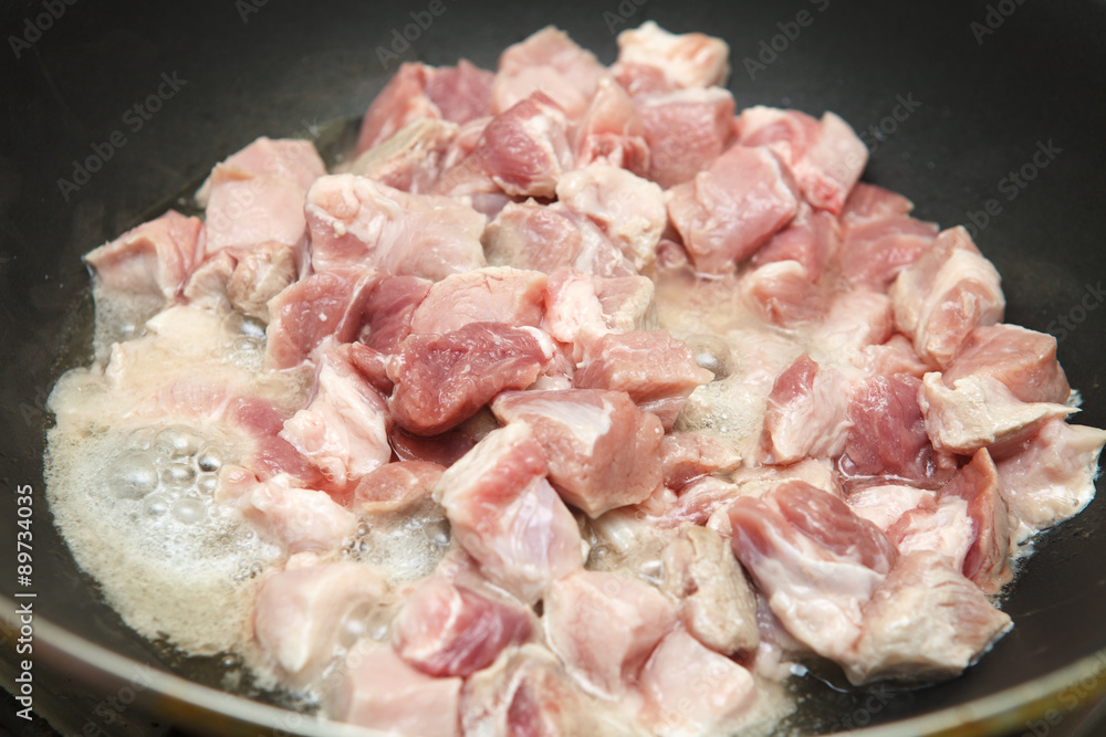 meat cut into pieces fried in a pan meat cut into pieces fried in a pan