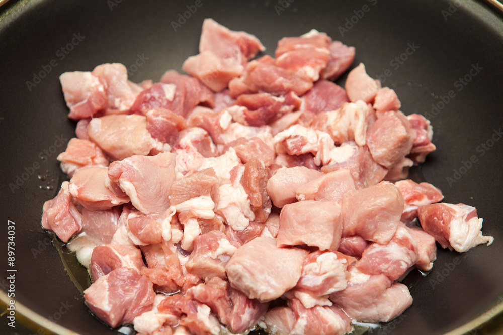 meat cut into pieces fried in a pan meat cut into pieces fried in a pan