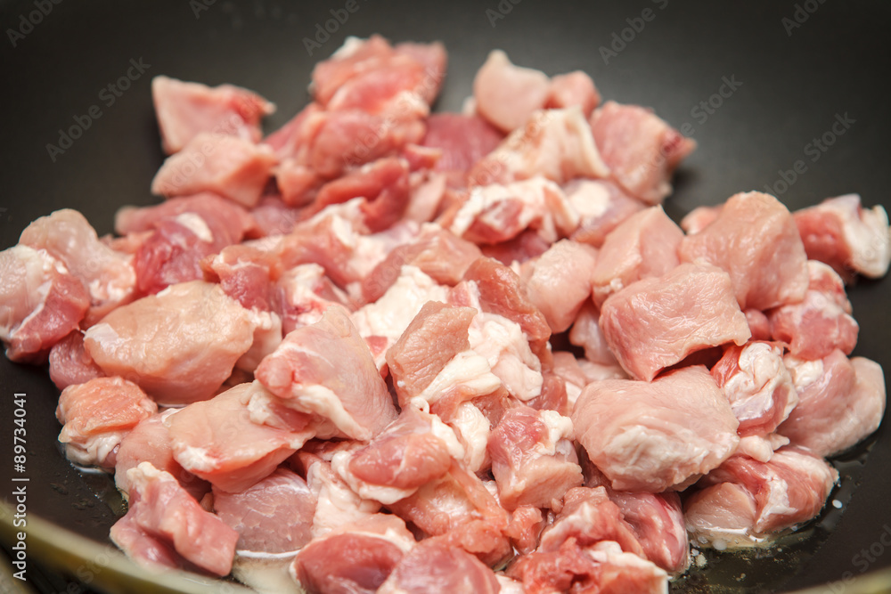 meat cut into pieces fried in a pan meat cut into pieces fried in a pan