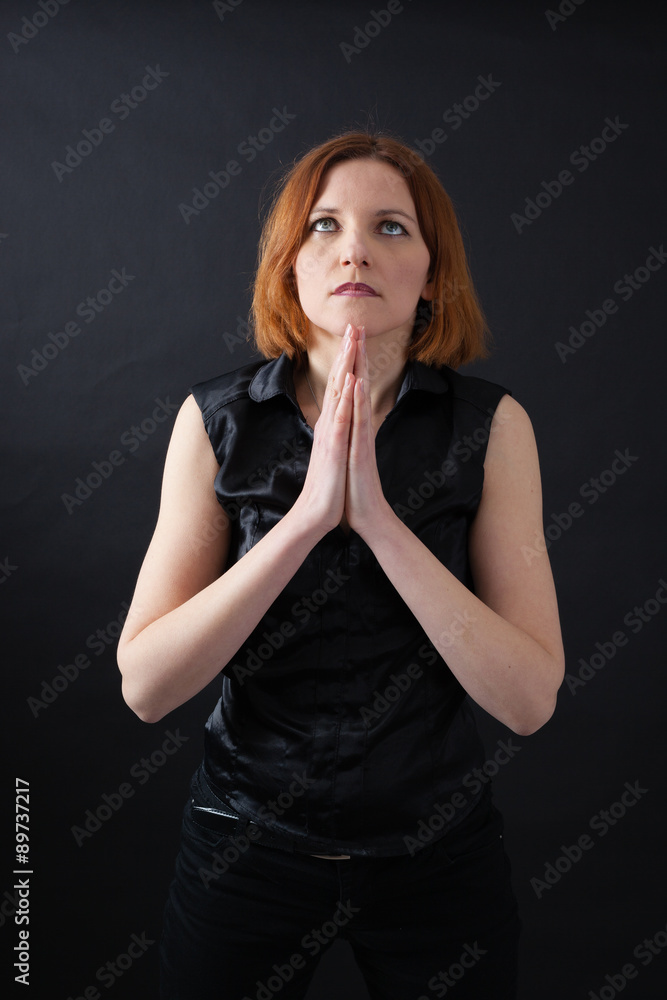 Beautiful woman doing different expressions in different sets of clothes: prayer