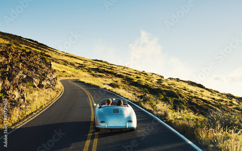 Stampa su Tela Coupe Driving on Country Road in Vintage Sports Car