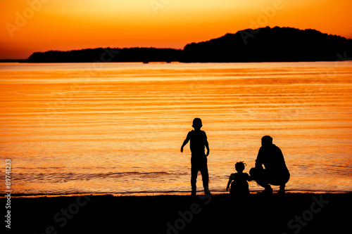 Father and children at sunset