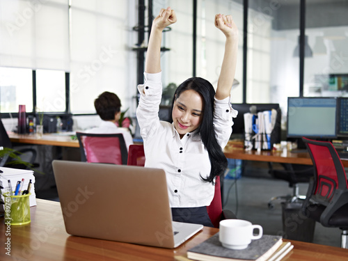 asian business woman celebrating completion of task