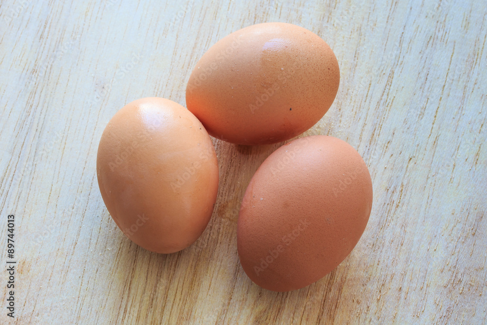 Three Eggs on Wooden Table.