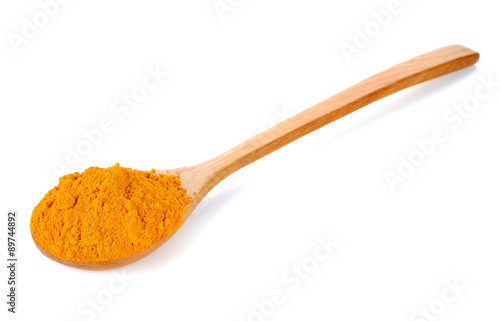 Turmeric (Curcuma) powder on wooden spoon isolated on white back