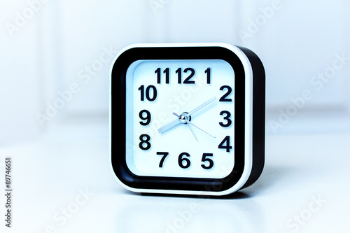 Modern Black and White Alarm Clock on White Background.