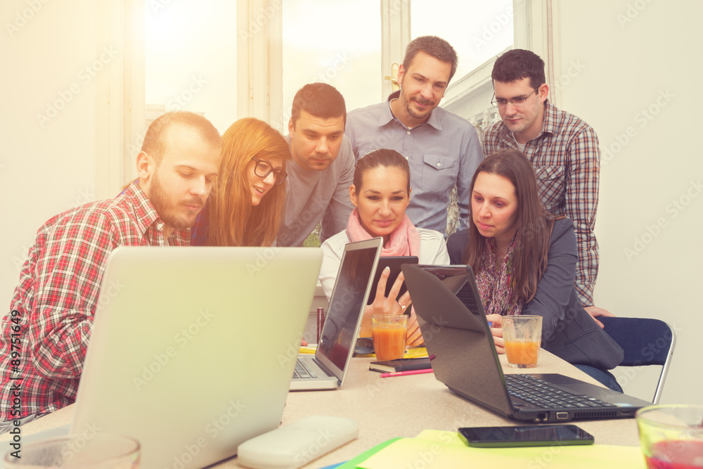 Young group of people discussing business plans. Young group of people discussing business plans.