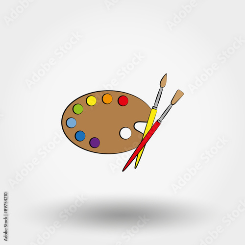 Wooden art palette with paints and brushes.